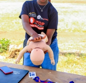 Infant first aid demonstration Trainee demonstrating infant back blows on a manikin at a Stop the Bleed event