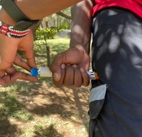 Auto-injector training Trainee practising with an epinephrine auto-injector trainer